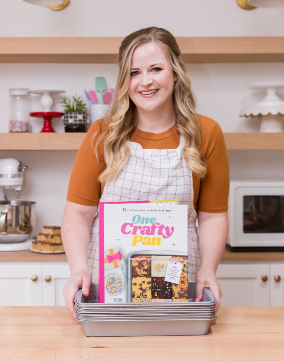 Melissa holding her One Crafty Pan cookbook